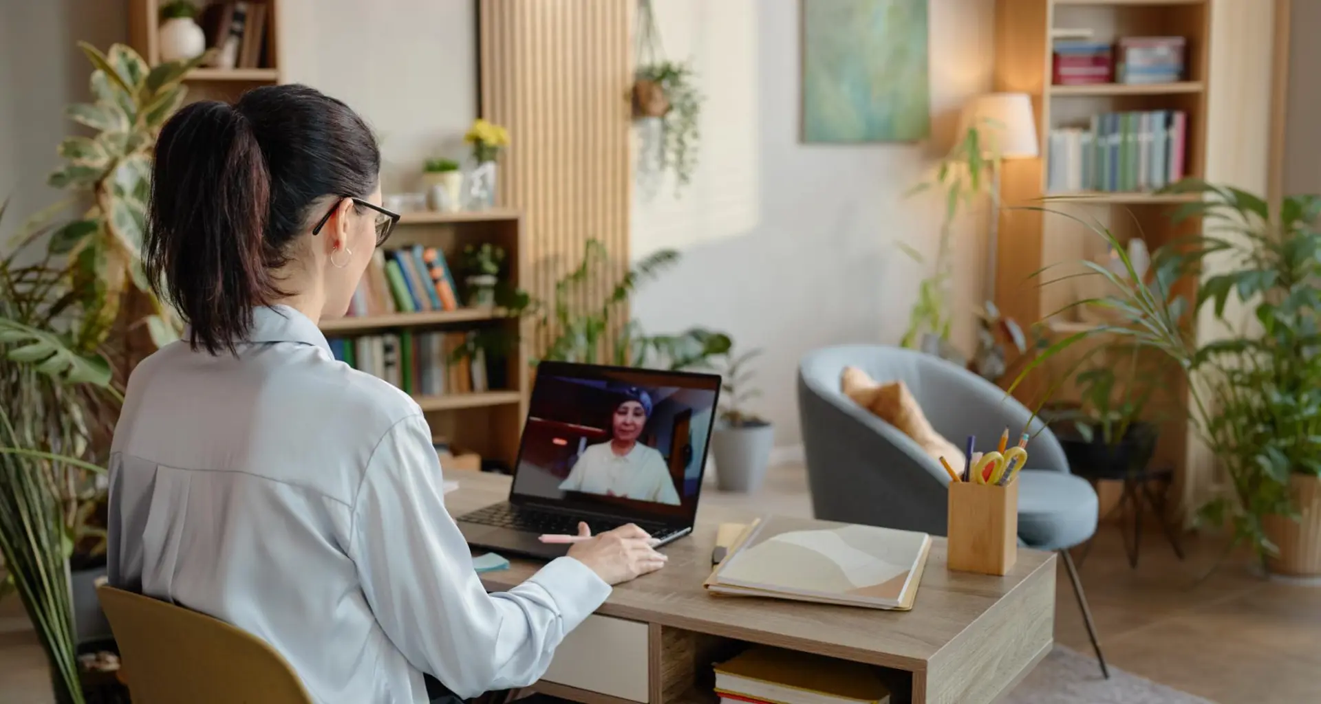 Woman at home on a video call with a counsellor on her laptop